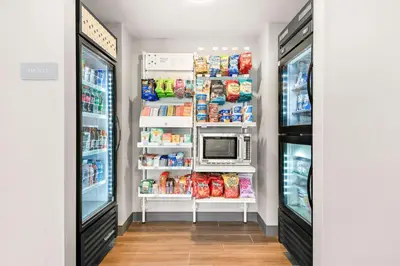 a kitchen with a refrigerator and a microwave at Spark By Hilton Exton in Exton