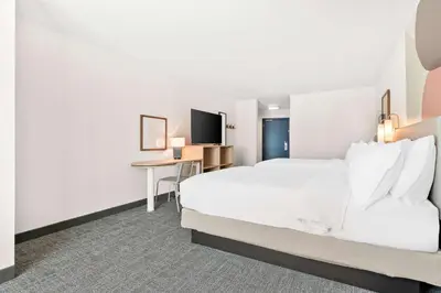 a hotel room with a bed and a desk at Spark By Hilton Exton in Exton
