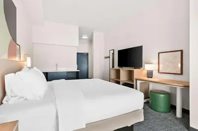 a hotel room with a white bed and a tv at Spark By Hilton Exton in Exton
