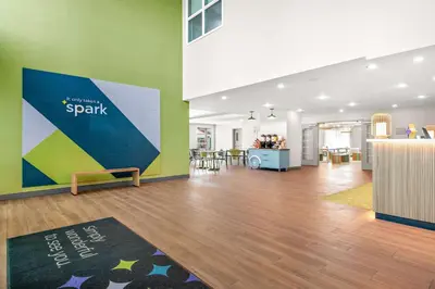 a living room with green walls and wooden floors at Spark By Hilton Exton in Exton