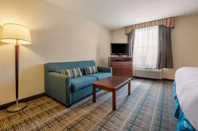 a hotel room with a couch and a bed at MainStay Suites Grantville - Hershey North in Grantville