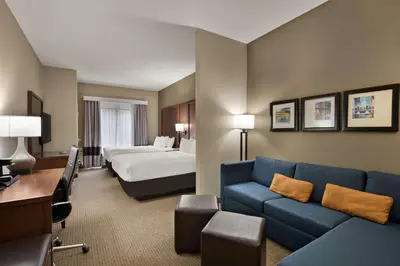 a hotel room with a couch and a bed at Comfort Suites Hummelstown - Hershey in Hummelstown