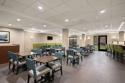 a dining room with tables and chairs at Comfort Suites Hummelstown - Hershey in Hummelstown