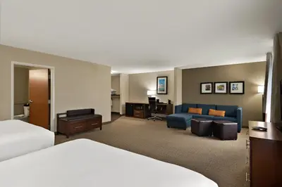 a hotel room with a bed and a couch at Comfort Suites Hummelstown - Hershey in Hummelstown