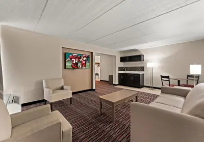 a living room with a couch and a table at Red Roof Inn Reading in Reading