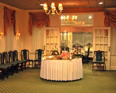 a large room with a table with flowers and chairs at Rodeway Inn & Suites Myerstown - Lebanon in Myerstown