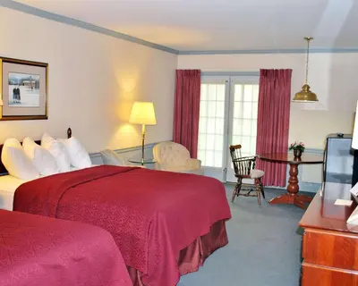 a hotel room with two beds and a television at Rodeway Inn & Suites Myerstown - Lebanon in Myerstown