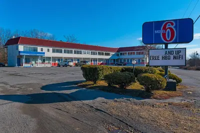 a store with a sign in front of a parking lot at Motel 6-Frackville, PA in Frackville