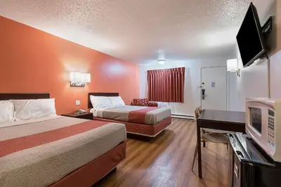 a hotel room with two beds and a flat screen tv at Motel 6-Frackville, PA in Frackville