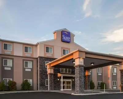 a hotel with a sign on top of it at Sleep Inn & Suites Harrisburg - Hershey North in Harrisburg