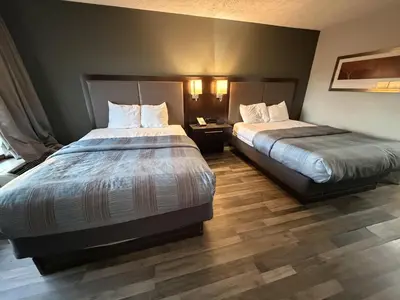 a hotel room with two beds in a room at Wilkes-Barre Inn & Suites in Wilkes-Barre