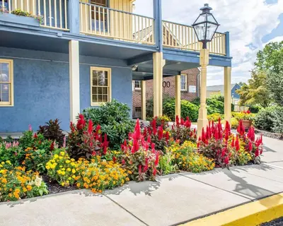 a flower garden in front of a building at Clarion Inn Strasburg - Lancaster in Strasburg