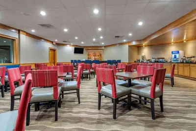 a restaurant with red chairs and tables in a room at Comfort Inn Lancaster County North in Denver
