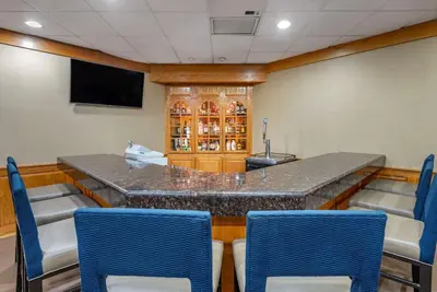 a bar in a room with chairs and a television at Comfort Inn Lancaster County North in Denver