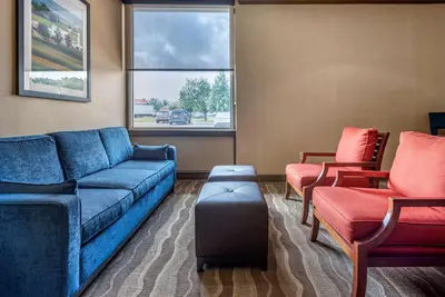 a living room with a couch and two chairs at Comfort Inn Lancaster County North in Denver