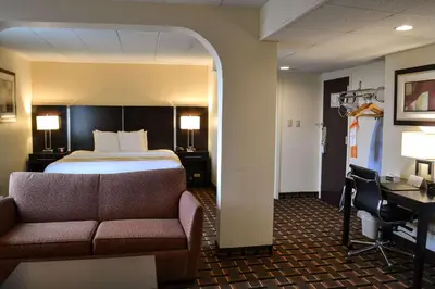 a hotel room with a bed and a couch at Comfort Inn Dunmore - Scranton East in Dunmore