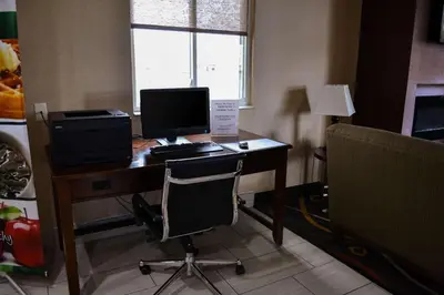 an office with a desk with a computer and a chair at Comfort Inn Dunmore - Scranton East in Dunmore
