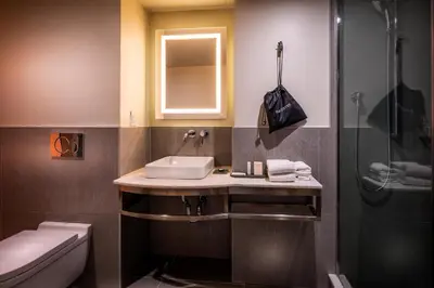 a bathroom with a sink and a shower at La Quinta by Wyndham Time Square South in New York