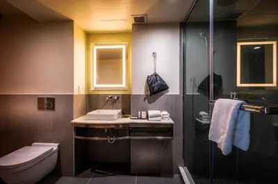 a bathroom with a sink and a toilet and a shower at La Quinta by Wyndham Time Square South in New York
