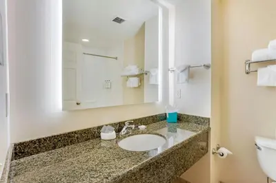 a bathroom with a sink and a toilet at The Prussia Hotel in King of Prussia