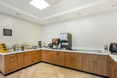 a large kitchen with wooden cabinets in a room at The Prussia Hotel in King of Prussia