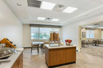 a kitchen and dining room with a table and chairs at The Prussia Hotel in King of Prussia