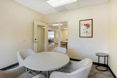 a meeting room with a white table and chairs at The Prussia Hotel in King of Prussia
