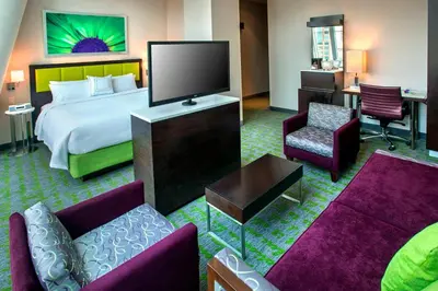 a hotel room with a bed and a flat screen tv at SpringHill Suites by Marriott New York Midtown Manhattan/Fifth Avenue in New York
