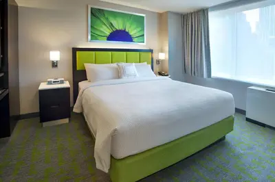 a bedroom with a large bed and a television at SpringHill Suites by Marriott New York Midtown Manhattan/Fifth Avenue in New York