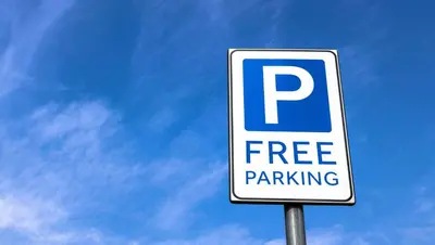a free parking sign in front of a blue sky at Country Place Inn and Suites White Haven in White Haven