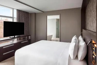 a hotel room with a bed and a television at Envue, Autograph Collection in Weehawken