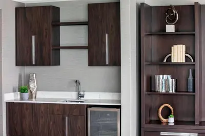 a kitchen with a sink and wooden cabinets at Envue, Autograph Collection in Weehawken