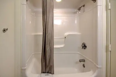 a shower with a white tub in a bathroom at Motel 6 King Of Prussia PA in King of Prussia