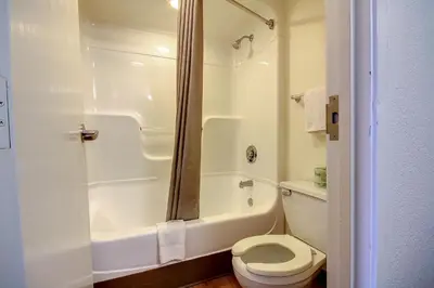 a white bathroom with a toilet and a shower at Motel 6 King Of Prussia PA in King of Prussia