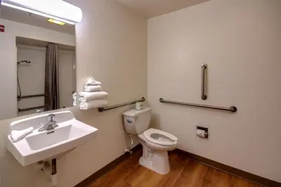 a bathroom with a sink and a toilet and a mirror at Motel 6 King Of Prussia PA in King of Prussia