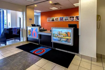 a lobby with a waiting room with a baseball at Motel 6 King Of Prussia PA in King of Prussia