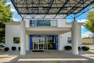 a building with a blue door in front of it at Motel 6 King Of Prussia PA in King of Prussia