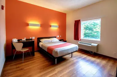 a bedroom with a bed and a desk and a window at Motel 6 King Of Prussia PA in King of Prussia