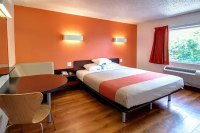 a bedroom with a bed and a desk and a table at Motel 6 King Of Prussia PA in King of Prussia
