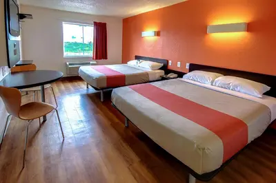 a hotel room with two beds and a table at Motel 6 King Of Prussia PA in King of Prussia