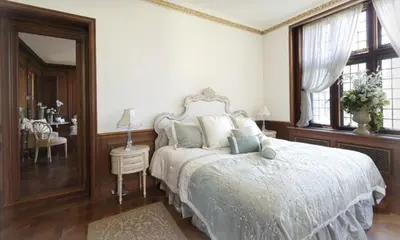 a bedroom with a white bed and a mirror at The Castle at Skylands Manor in Ringwood