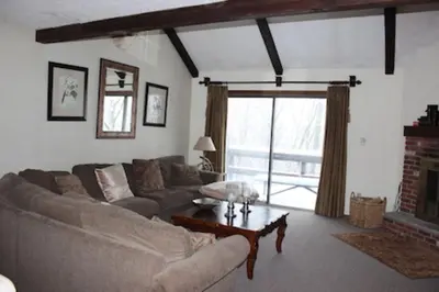 a living room with a couch and a fireplace at 106 Village at Camelback in Tannersville