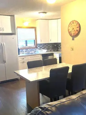 a kitchen with a table and a clock on the wall at 106 Village at Camelback in Tannersville