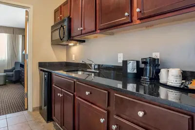 a kitchen with a sink and a counter top at Best Western Plus Philadelphia Airport South - at Widener University in Chester