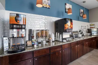 a kitchen with a counter with a coffee shop at Best Western Plus Philadelphia Airport South - at Widener University in Chester