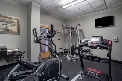 a room with a gym with a bike and a treadmill at Best Western Plus Philadelphia Airport South - at Widener University in Chester