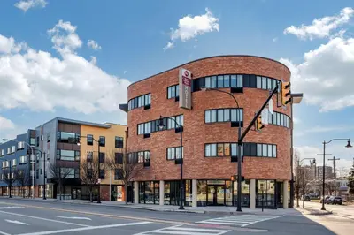 a brick building on the corner of a street at Best Western Plus Philadelphia Airport South - at Widener University in Chester