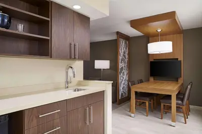 a kitchen with a table and a dining room at Hyatt Place Wilmington Riverfront in Wilmington
