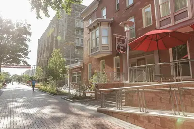 a person walking down a street with a red umbrella at The Conwell Inn in Philadelphia