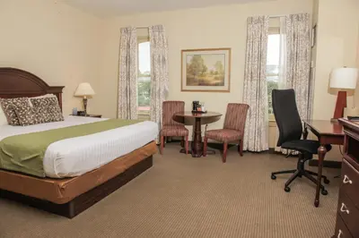 a hotel room with a bed and a table and chairs at The Conwell Inn in Philadelphia